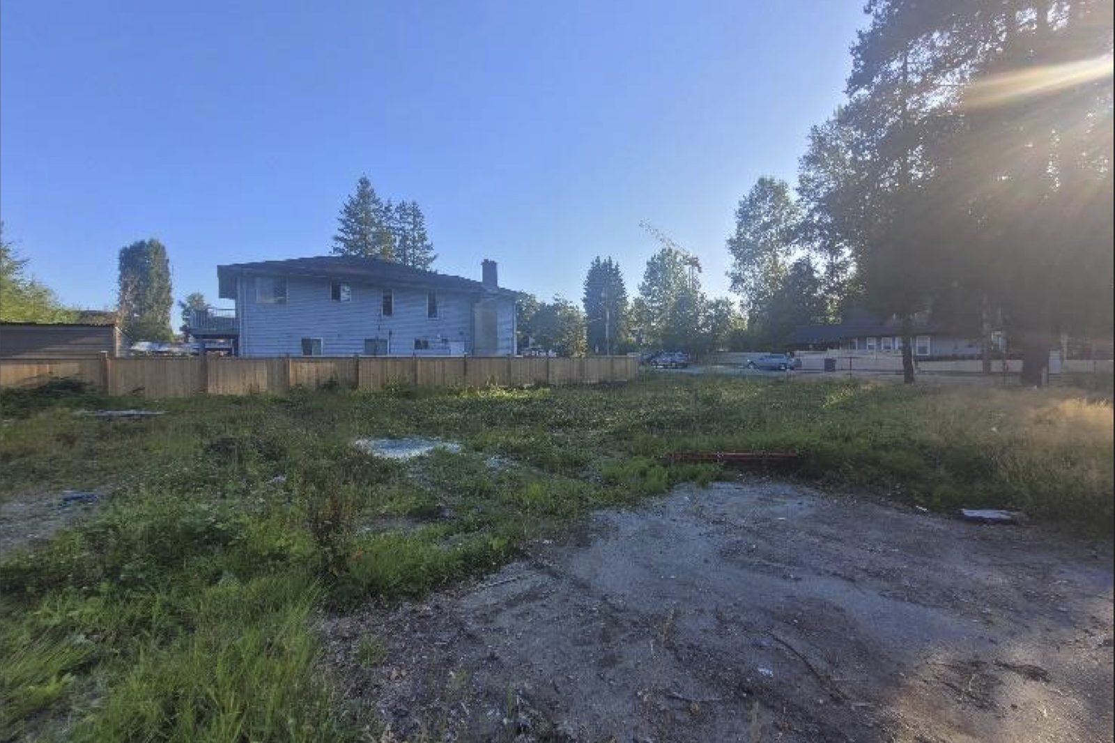 The vacant, cleared and fenced lot at 14310 104 Avenue, looking across the site.